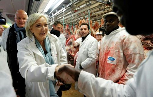 The atmosphere was cordial for the most part during Le Pen's visit to Europe's biggest wholesale fresh food market, but she also drew boos
