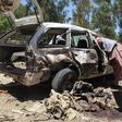 Afghan residents gather at the scene of a suicide car bomb that targeted a CIA-funded pro-government militia force at a public bus station in Khost province on May 27, 2017