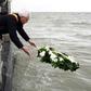 West-Flanders province governor Carl Decaluwe throws a wreath to the sea during a tribute ceremony for the 30th anniversary of the Herald of Free Enterprise ferry disaster