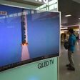 A man walks past a television showing a news report on North Korea's latest missile test in Seoul
