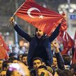 People wave Turkish national flags during a demostration near the Turkish consulate in Rotterdam on March 11, 2017