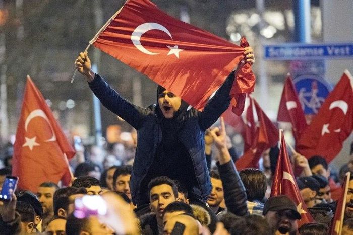 People wave Turkish national flags during a demostration near the Turkish consulate in Rotterdam on March 11, 2017