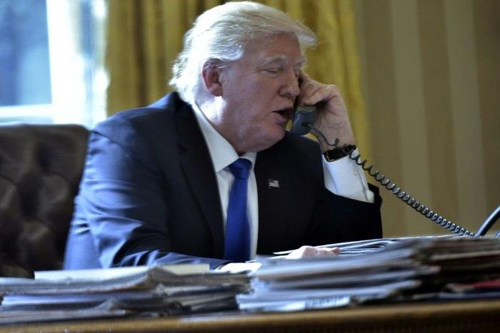 US President Donald Trump speaks on the phone with Russia's President Vladimir Putin from the White House on January 28, 2017