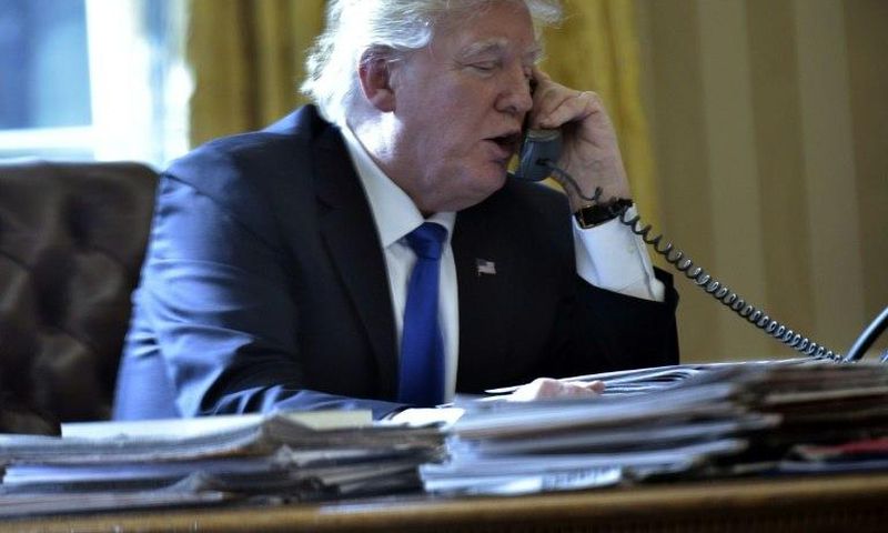 US President Donald Trump speaks on the phone with Russia's President Vladimir Putin from the White House on January 28, 2017