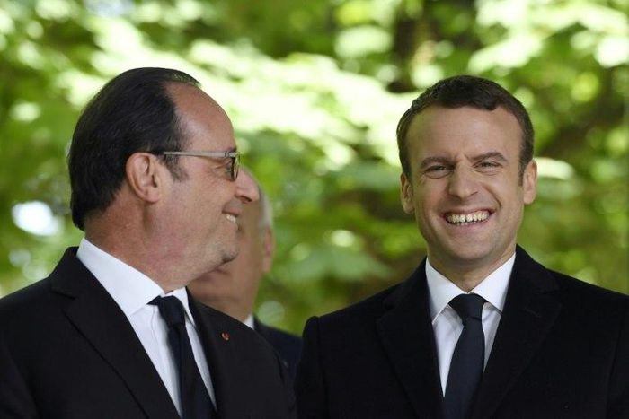 French President Francois Hollande (left) is pictured on Wednesday with his successor centrist Emmanuel Macron