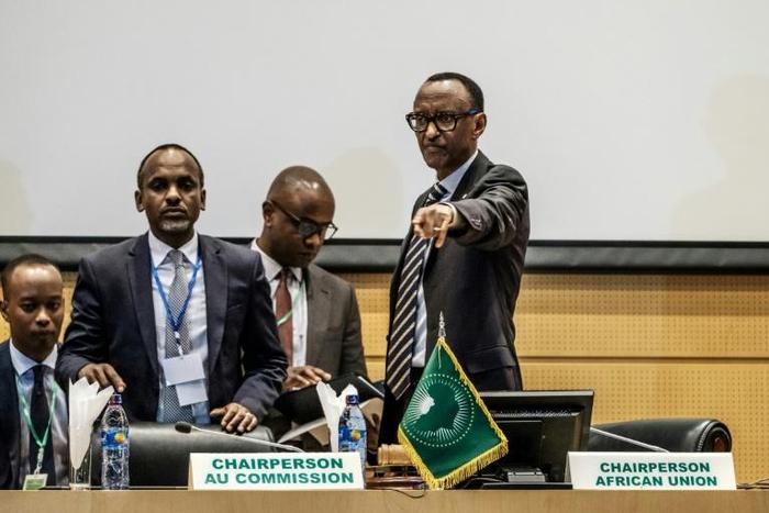 African Union chairperson and Rwanda's President Paul Kagame (R) gestures at the beginning of an African Union High Level Consultation Meeting with African leaders regarding the DR Congo election