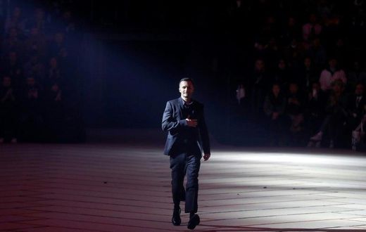 Artistic director for Dior Homme, Belgian fashion designer Kris Van Assche, acknowledges the public at the end of the men's Fashion Week for the Fall/Winter 2017/2018 collection in Paris on January 20, 2017