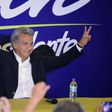 Lenin Moreno, the presidential candidate of the governing Alianza PAIS party, makes the "V for victory" sign to supporters at a hotel in Quito shortly before the results of the country's general elections are announced on February 19, 2017
