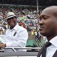 Ivory Coast's President Alassane Ouattara (C) smiles and greets supporters as he arrives for a rally on October 22, 2016, ahead of a referendum on the adoption of a new constitution