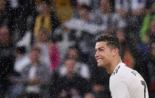 Cristiano Ronaldo looks on through drops of champagne after Juventus won an eighth straight Serie A title.