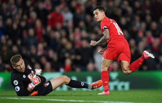 Liverpool's midfielder Philippe Coutinho (R) watches hsi shot beat Bournemouth's Polish goalkeeper Artur Boruc during the English Premier League football match between Liverpool and Bournemouth at Anfield in Liverpool, on April 5, 2017