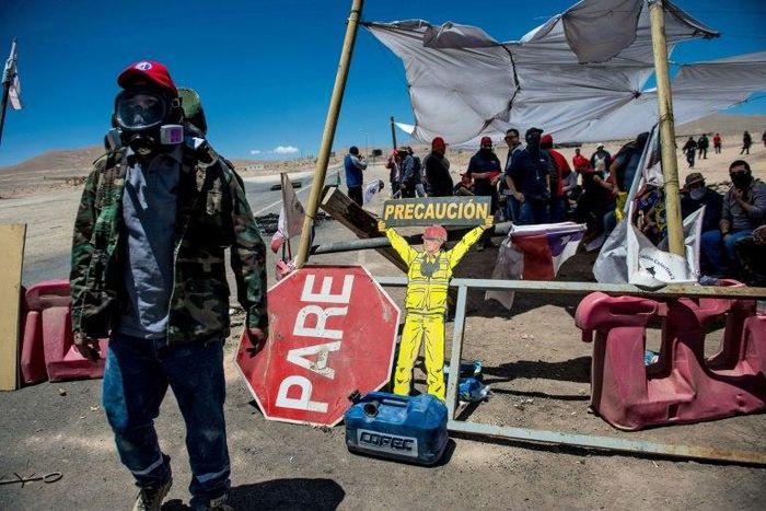 Workers of the Escondida copper mine block a road as they strike in Antofagasta, Chile, on February 15, 2017