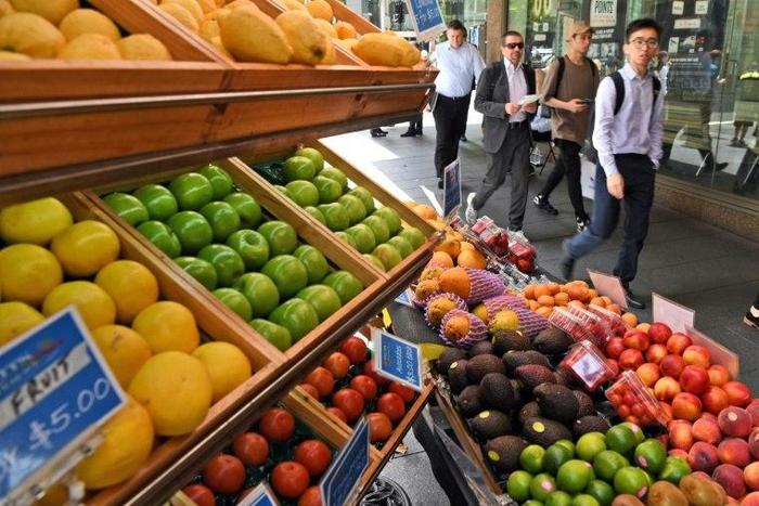 A fruit vendor tends to his stall in Sydney's central business district on November 29, 2016