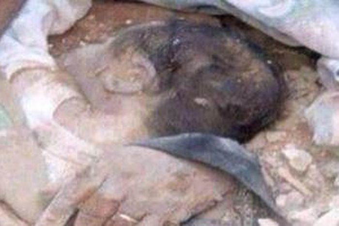 The buried baby being rescued