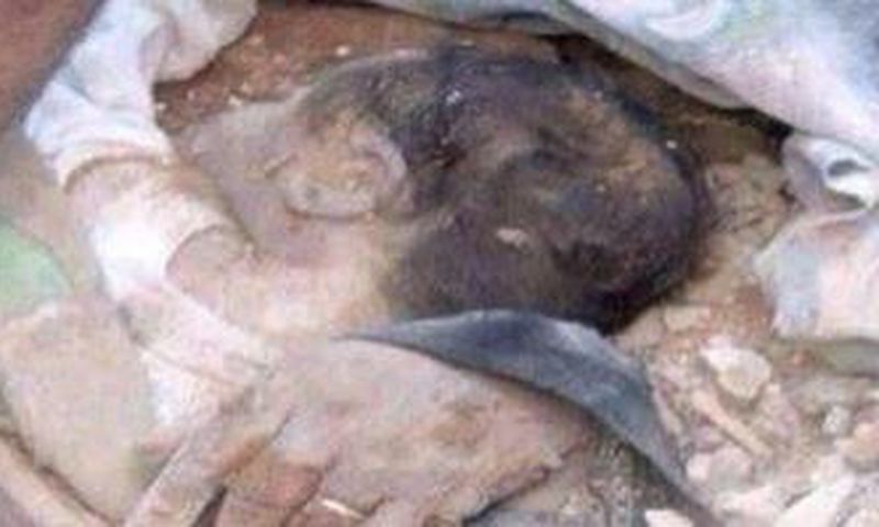 The buried baby being rescued