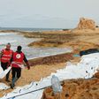 Libyan Red Crescent volunteers recovering the bodies of 74 migrants that washed ashore on February 20 near Zawiyah on Libya’s northern coast on February 21, 2017