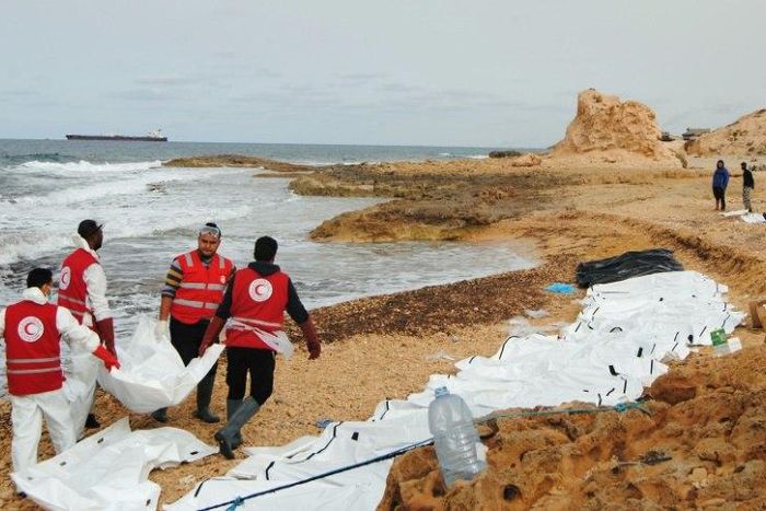 Libyan Red Crescent volunteers recovering the bodies of 74 migrants that washed ashore on February 20 near Zawiyah on Libya’s northern coast on February 21, 2017