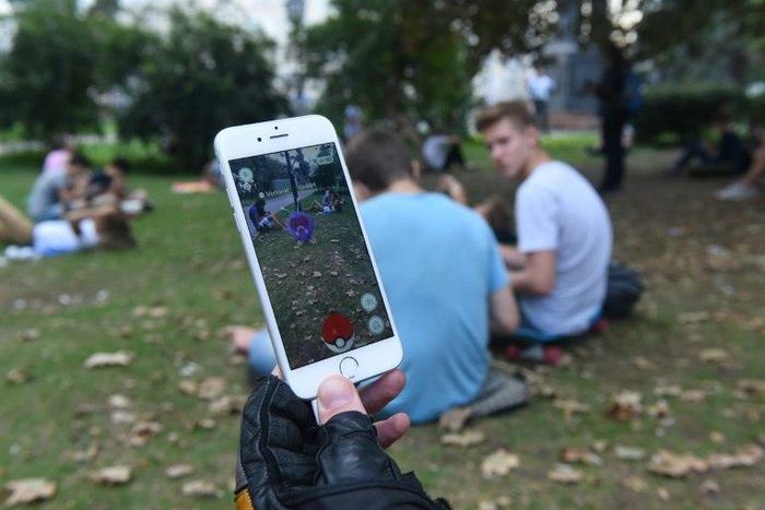 Hunting Pokemon at a park in Russia, where a blogger is on trial for posting a video of him playing the game in a church