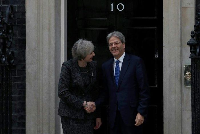 British Prime Minister Theresa May shakes hands with her Italian counterpart Paolo Gentiloni outside No. 10 Downing Street in London, on February 9, 2017