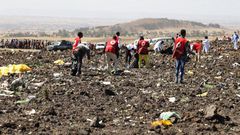 Red Cross officials recover bodies form the scene of the Ethiopian Airlines ET 302 plane crash (Twitter)