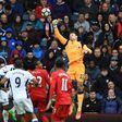 Liverpool's goalkeeper Simon Mignolet (R) punches the ball clear during the English Premier League football match between West Bromwich Albion and Liverpool at The Hawthorns stadium in West Bromwich, central England, on April 16, 2017