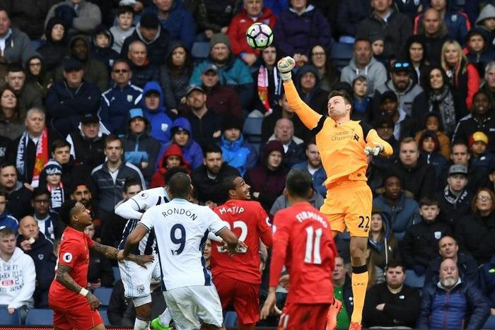 Liverpool's goalkeeper Simon Mignolet (R) punches the ball clear during the English Premier League football match between West Bromwich Albion and Liverpool at The Hawthorns stadium in West Bromwich, central England, on April 16, 2017