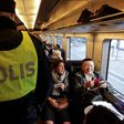 Swedish police carry out identity checks on the train from Copenhagen, Denmark, to Malmo, Sweden, on November 12, 2015