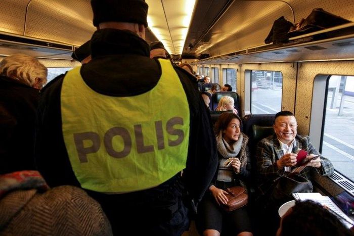 Swedish police carry out identity checks on the train from Copenhagen, Denmark, to Malmo, Sweden, on November 12, 2015