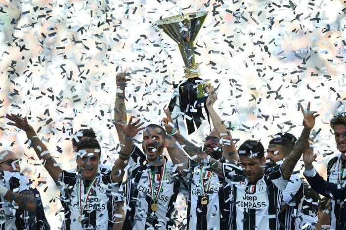 Juventus' players celebrate with the trophy after winning the "Scudetto" at the Juventus Stadium in Turin on May 21, 2017