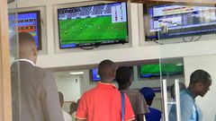 Kenyans place their bets at one of the many betting spots in Nairobi on July 30, 2016, along Market Street.