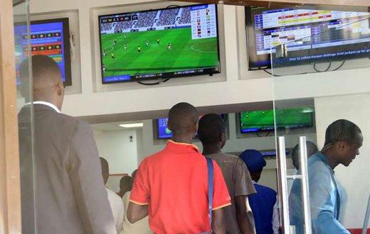 Kenyans place their bets at one of the many betting spots in Nairobi on July 30, 2016, along Market Street.