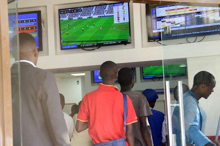 Kenyans place their bets at one of the many betting spots in Nairobi on July 30, 2016, along Market Street.
