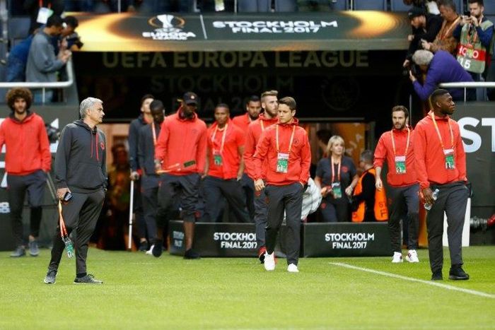 Manchester United manager Jose Mourinho (2nd L) and his players walk onto the pitch at the Friends Arena in Solna outside Stockholm on May 23, 2017, on the eve of the Europa League final against Ajax Amsterdam