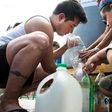 People get water during a drinking water supply cut in Santiago, on February 26, 2017