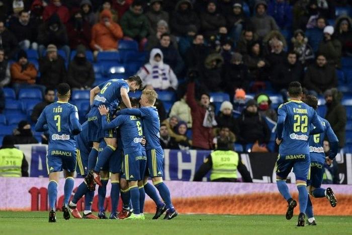 Celta Vigo players celebrate after scoring their second goal during their Spanish Copa del Rey quarter-final first leg against Real Madrid at the Santiago Bernabeu stadium in Madrid on January 18, 2017
