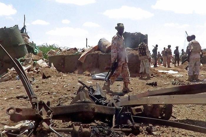 African Union soldiers from Djibouti stand at the site of a car bomb attack at an African Union army base in central Somalia on October 25, 2016