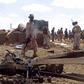 African Union soldiers from Djibouti stand at the site of a car bomb attack at an African Union army base in central Somalia on October 25, 2016
