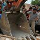 Residents rescue an earthquake survivor from rubble in Pidie Jaya, Indonesia's Aceh province, on December 7, 2016