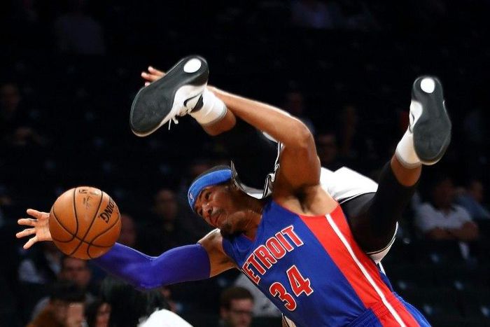 Tobias Harris of the Detroit Pistons and Trevor Booker of the Brooklyn Nets collide going for the ball during the game October 6, 2016 in New York City