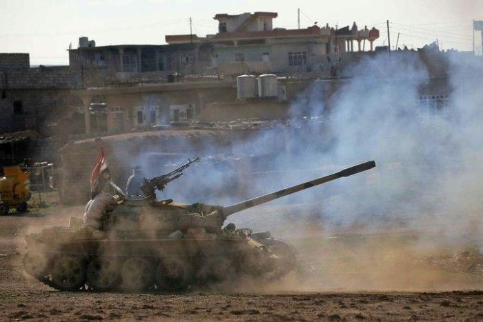 Iraqi government forces supported by fighters from the Abbas Brigade, advance in village of Badush some 15 kilometres northwest of Mosul during the ongoing battle to retake the city's west from Islamic State group March 7, 2017