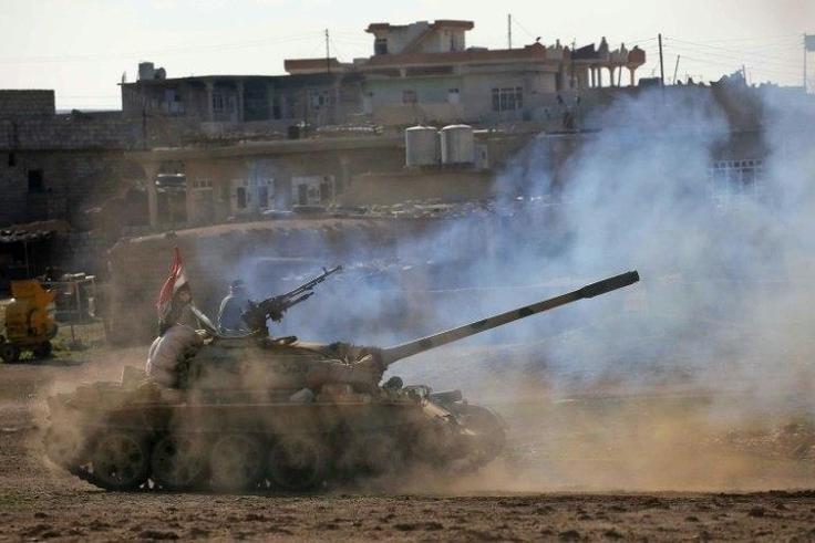 Iraqi government forces supported by fighters from the Abbas Brigade, advance in village of Badush some 15 kilometres northwest of Mosul during the ongoing battle to retake the city's west from Islamic State group March 7, 2017