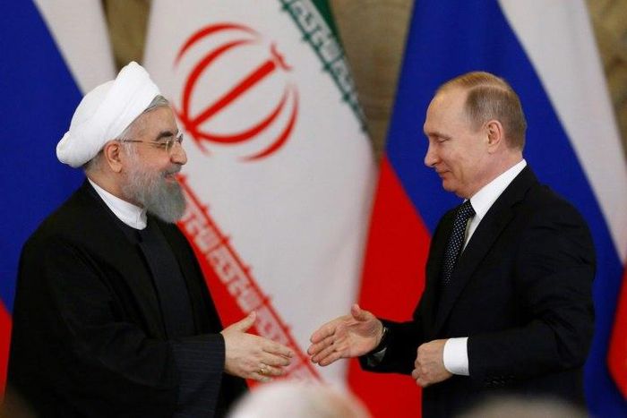 Russian President Vladimir Putin (R) shakes hands with his Iranian counterpart Hassan Rouhani during a joint press conference following their meeting at the Kremlin in Moscow on March 28, 2017