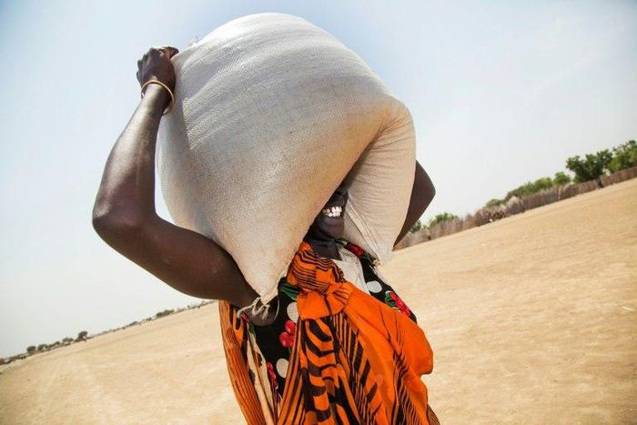 A woman carries a sack of food distributed in Ganyiel, Panyijiar county, in South Sudan