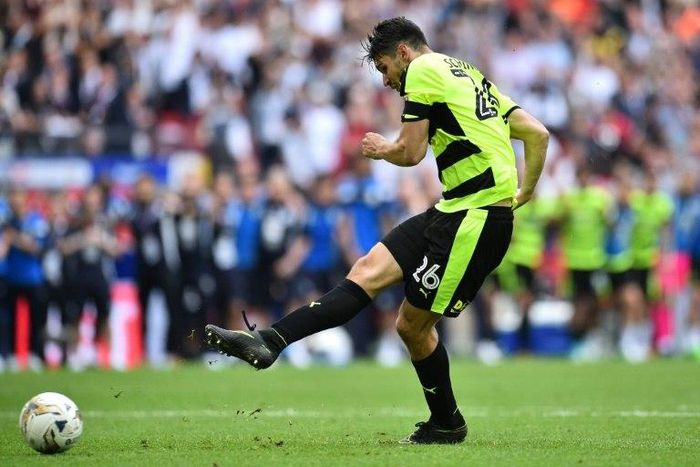 Huddersfield Town's German defender Christopher Schindler scores the final penalty in the shoot-out during the English Championship play-off final football match between Huddersfield Town and Reading at Wembley Stadium in London on May 29, 2017