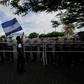 An activist waves a national flag during a march against the construction of the Interoceanic Grand Canal and denouncing what they claim to be electoral fraud in the November 6 elections Nicaragua, in Managua on December 1, 2016