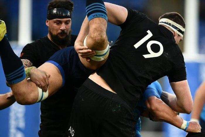 New Zealand's players tackle Italy's Francesco Minto (C) during their rugby union Test match at the Olympic Stadium in Rome, on November 12, 2016