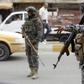 Iraqi security forces patrol a Baghdad street