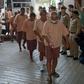 Some of the dozens of people arrested in a crackdown on human trafficking arrive in court to present their defence