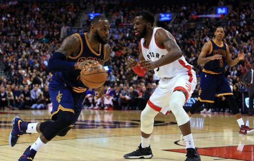 LeBron James of the Cleveland Cavaliers dribbles the ball past DeMarre Carroll of the Toronto Raptors on December 5, 2016 in Toronto, Canada