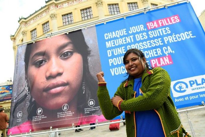Radha Rani Sarker, who escaped forced marriage at the age of 14 in Bangladesh, pictured in front of NGO Plan International's campaign poster in Paris on the eve of the UN International Day of the Girl Child, on October 10, 2016